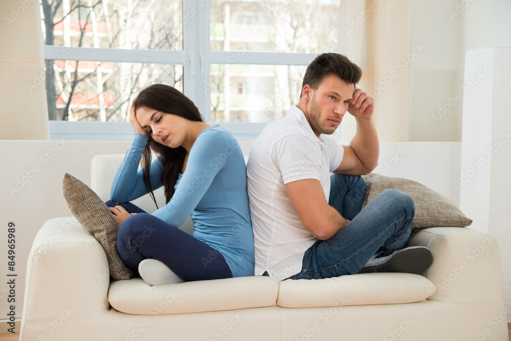 Displeased Couple Sitting On Couch After Quarrel Displeased Couple Sitting On Couch After Quarrel