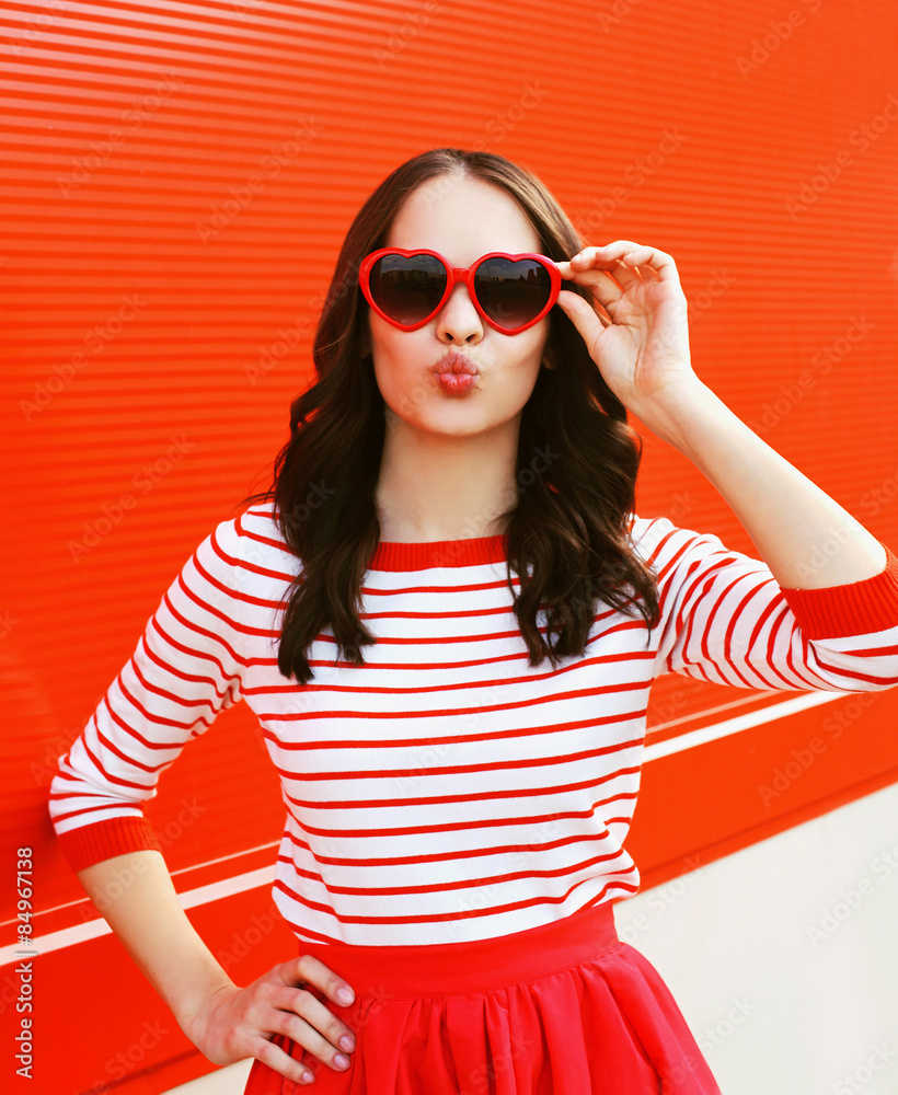 Portrait of pretty woman in red sunglasses blowing lips having f Portrait of pretty woman in red sunglasses blowing lips having f