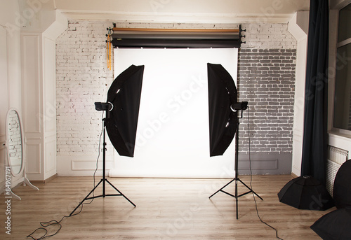 Empty photo studio interior with white background and lighting e