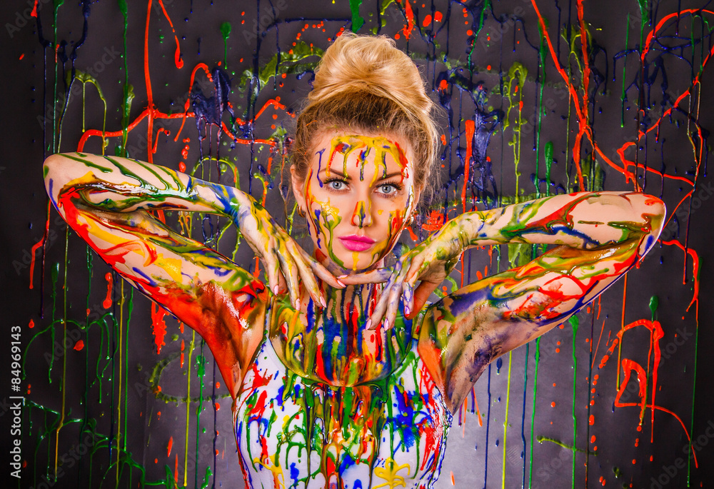 Fototapeta premium Beautiful young woman covered with paints