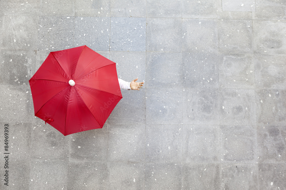 Man holding a red umbrella - obrazy, fototapety, plakaty 