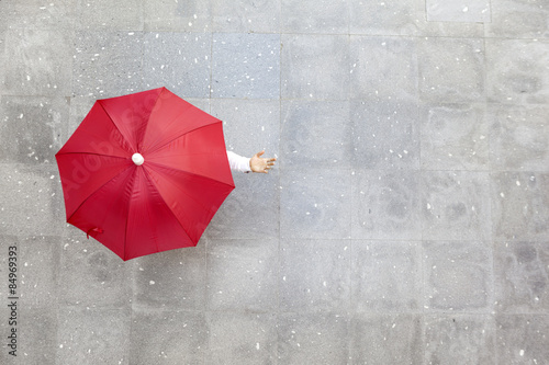 Man holding a red umbrella photo