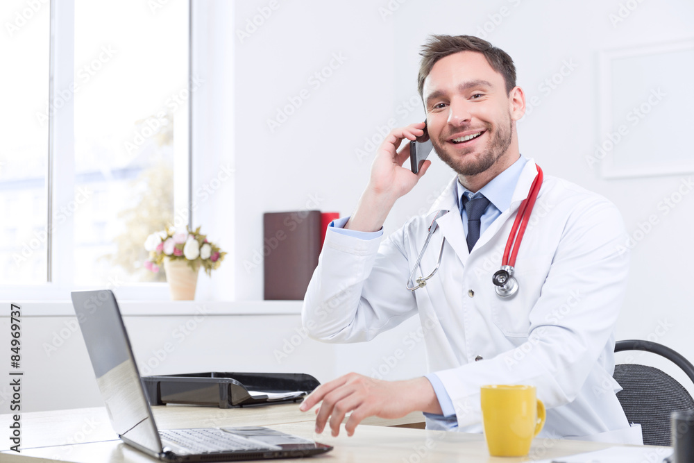 Nice cardiologist talking on the mobile phone Nice cardiologist talking on the mobile phone
