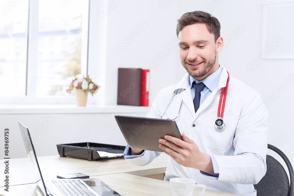 Nice doctor holding the laptop