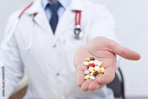 Professional doctor giving pills