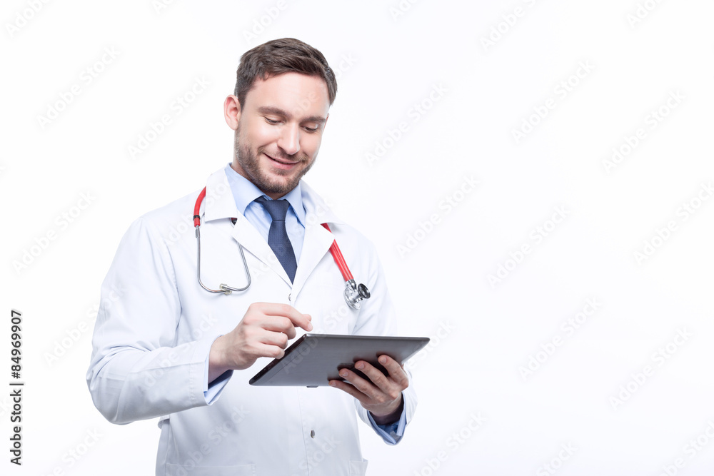 Handsome doctor holding the laptop