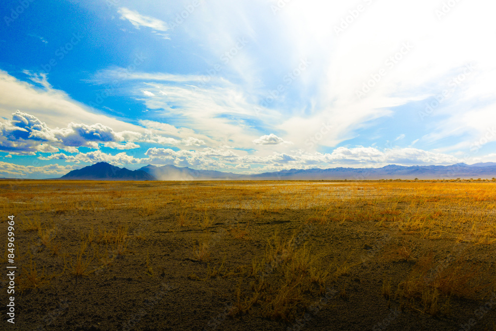 Sweeping clouds over an empty desert pasture on an early winter day near Death Valley, CA Sweeping clouds over an empty desert pasture on an early winter day near Death Valley, CA