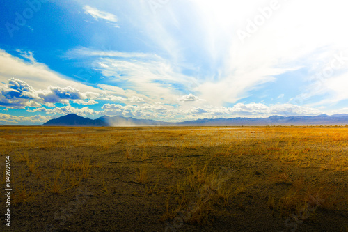Sweeping clouds over an empty desert pasture on an early winter day near Death Valley, CA