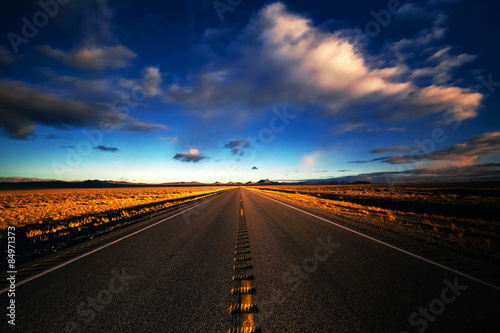 Clouds blur over a desert highway on a stretch from Lake Tahoe to Las Vegas near Gardnerville, Nevada