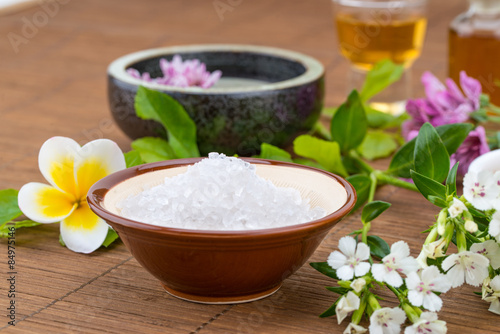 salt bowl, essential oil, flower float on water china backgroun