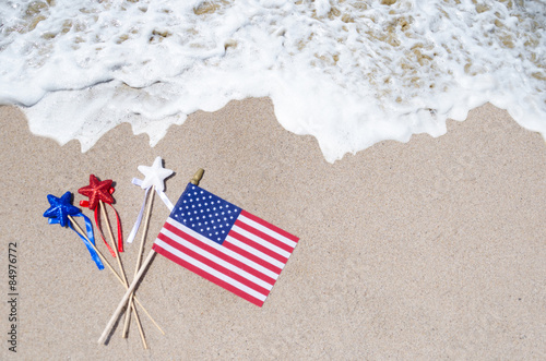 American flag with stars on the sandy beach
