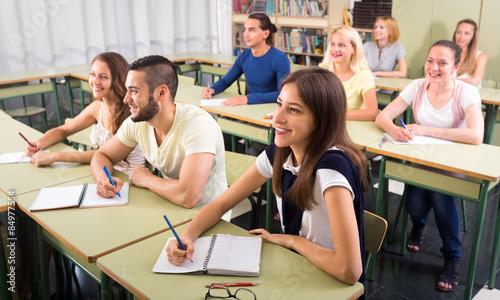 Happy students in college classroom photo