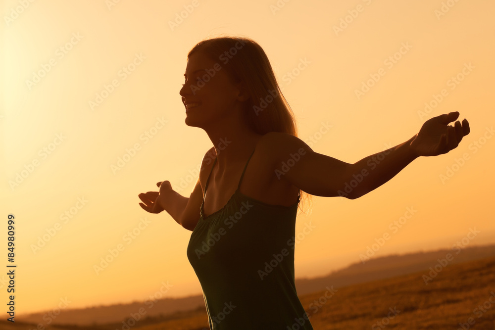 Young woman enjoying sunset