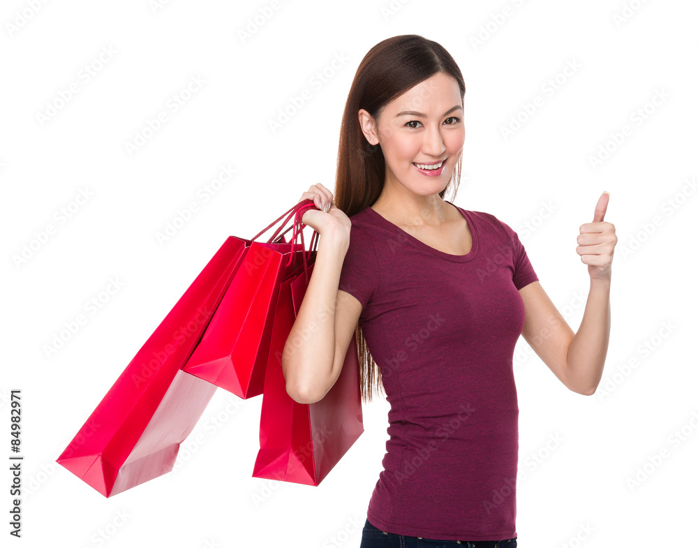 Asian woman holding with shopping bag and thumb up Asian woman holding with shopping bag and thumb up
