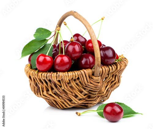 Basket full of fresh red cherry on a white background