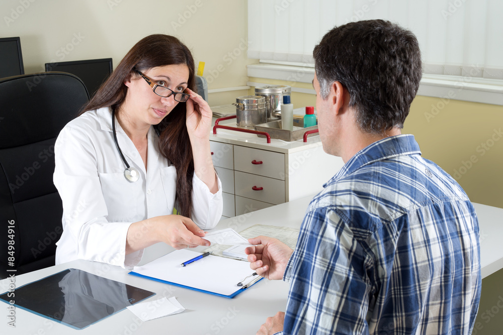 Female Doctor Giving Recipe to a Patient in Doctor's Office Female Doctor Giving Recipe to a Patient in Doctor's Office