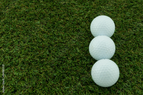 Three golf ball on grass, Closeup shoot.