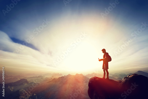 Man connecting with his smartphone on top of the mountain. Communication
