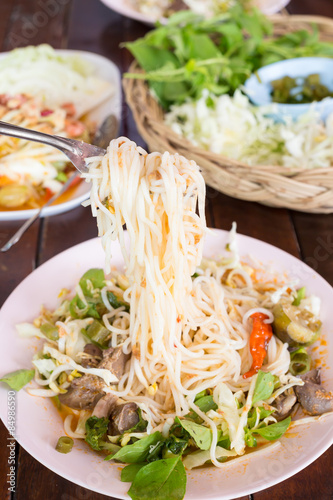 Knomjean, Thai rice vermicelli served with curry on wood table