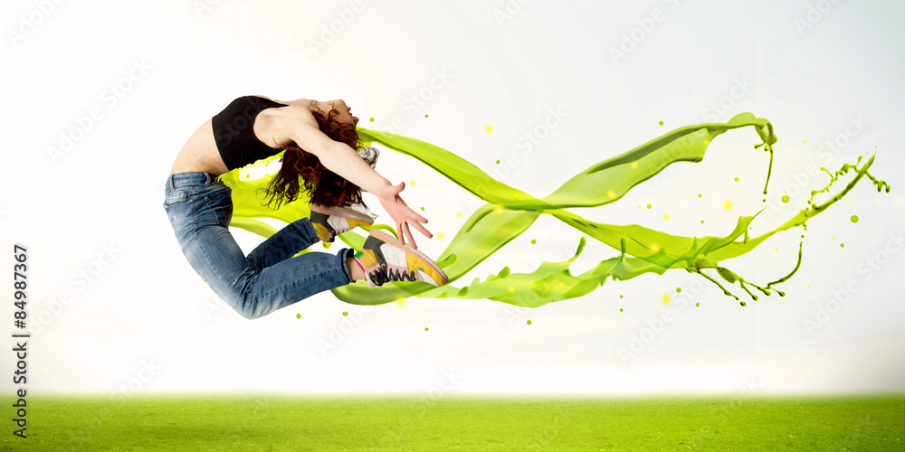 Fototapeta premium Pretty girl jumping with green abstract liquid dress