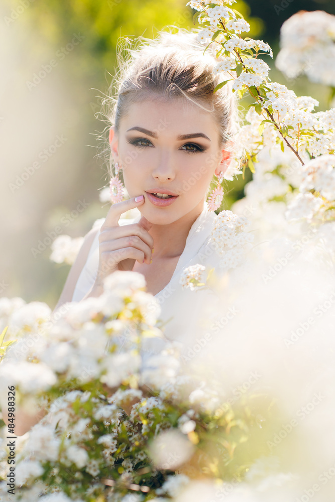 Beautiful happy woman in a flowery spring garden. Beautiful happy woman in a flowery spring garden.