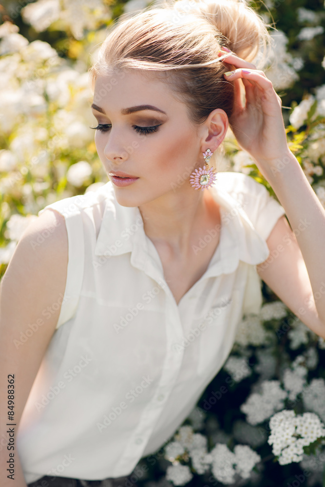Beautiful happy woman in a flowery spring garden. Beautiful happy woman in a flowery spring garden.