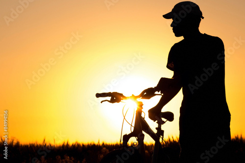 silhouette of a bike wheel in the field