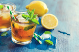 Fresh cold iced tea with mint, ice and lemons, refreshing drink,