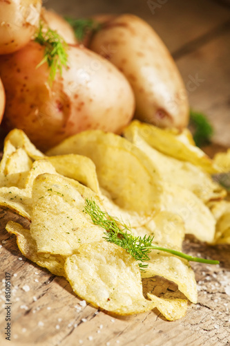 Fototapeta Naklejka Na Ścianę i Meble -  Fresh potatoes and potato chips, selective focus