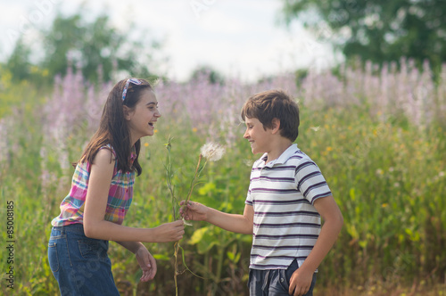 Children blowing dandelion