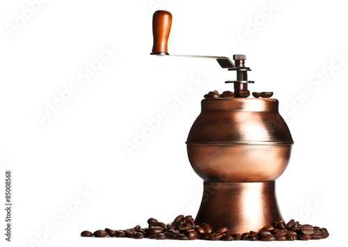 vintage coffee grinder standing on beans photo