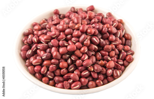 Red adzuki beans in white bowl over white background