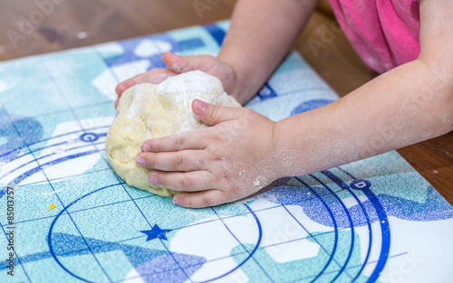 Close up of child hands making dough