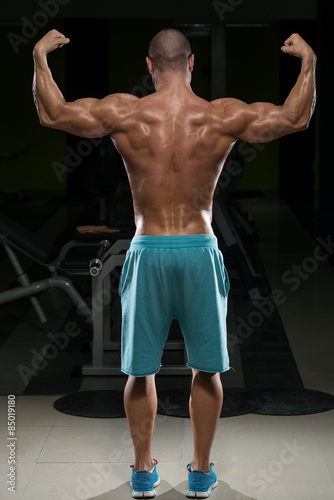 Physically Fit Man Performing Rear Double Biceps Pose