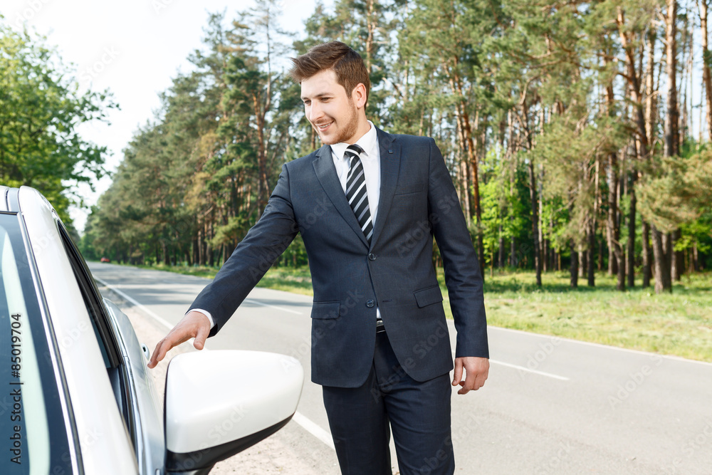 Businessman opening door of car Businessman opening door of car