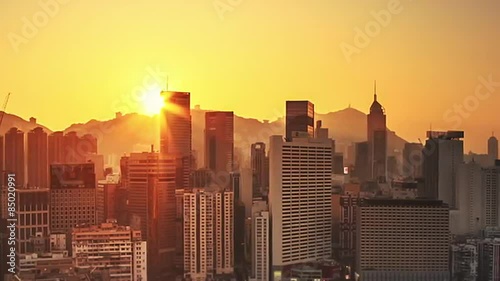 Hong Kong sunrise cityscape skyline. Warm yellow sun with scenic rays of light