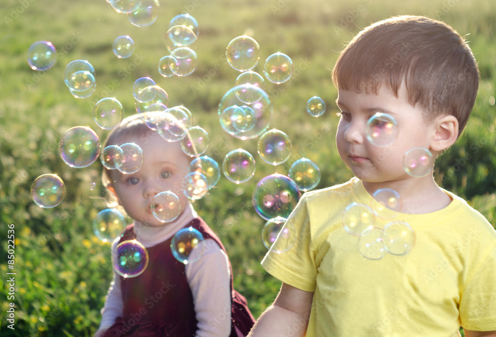 Children playing with soap bubbles Children playing with soap bubbles