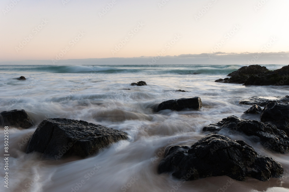 Milky smooth water running over rocks