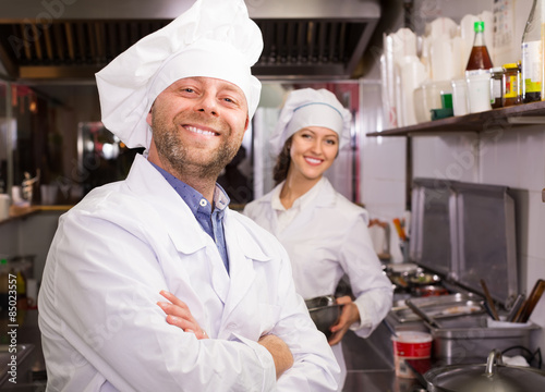 Chef and his helper at bistro kitchen