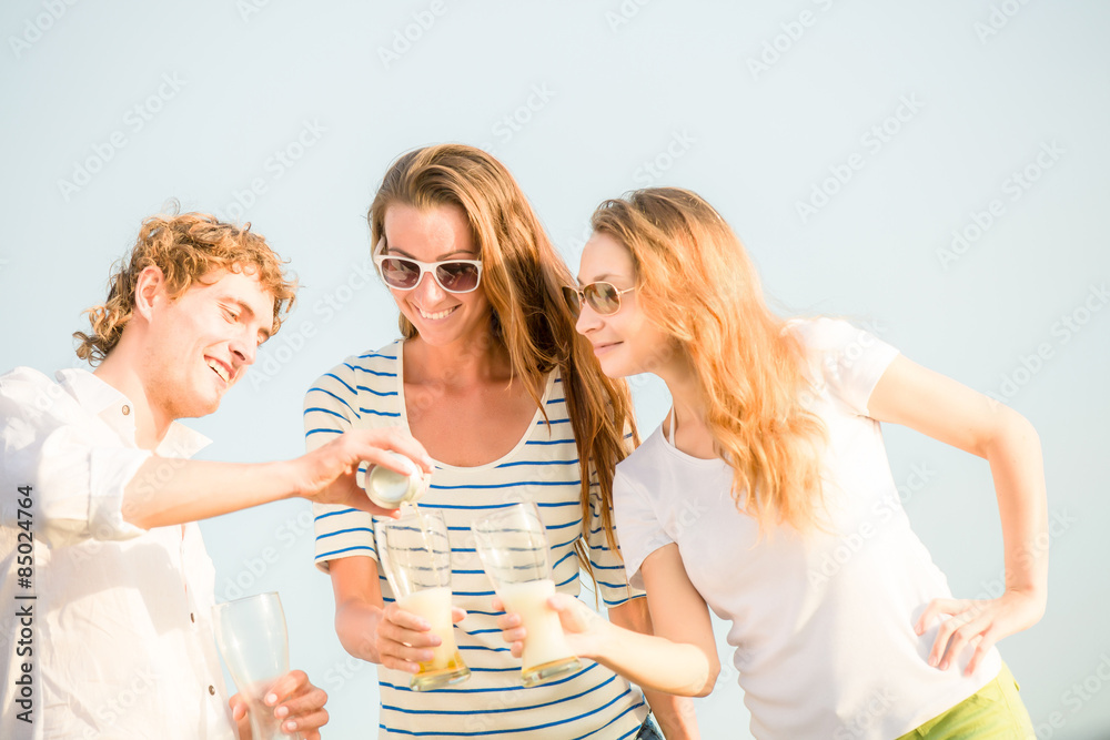 Group of happy young people drinking beer on the beach Group of happy young people drinking beer on the beach