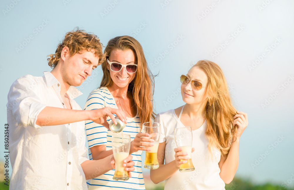 Group of happy young people drinking beer on the beach Group of happy young people drinking beer on the beach