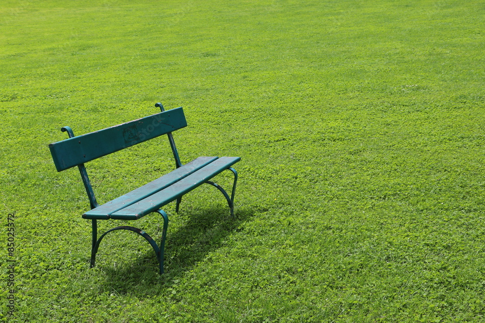 Lonely bench on short cut grass Lonely bench on short cut grass