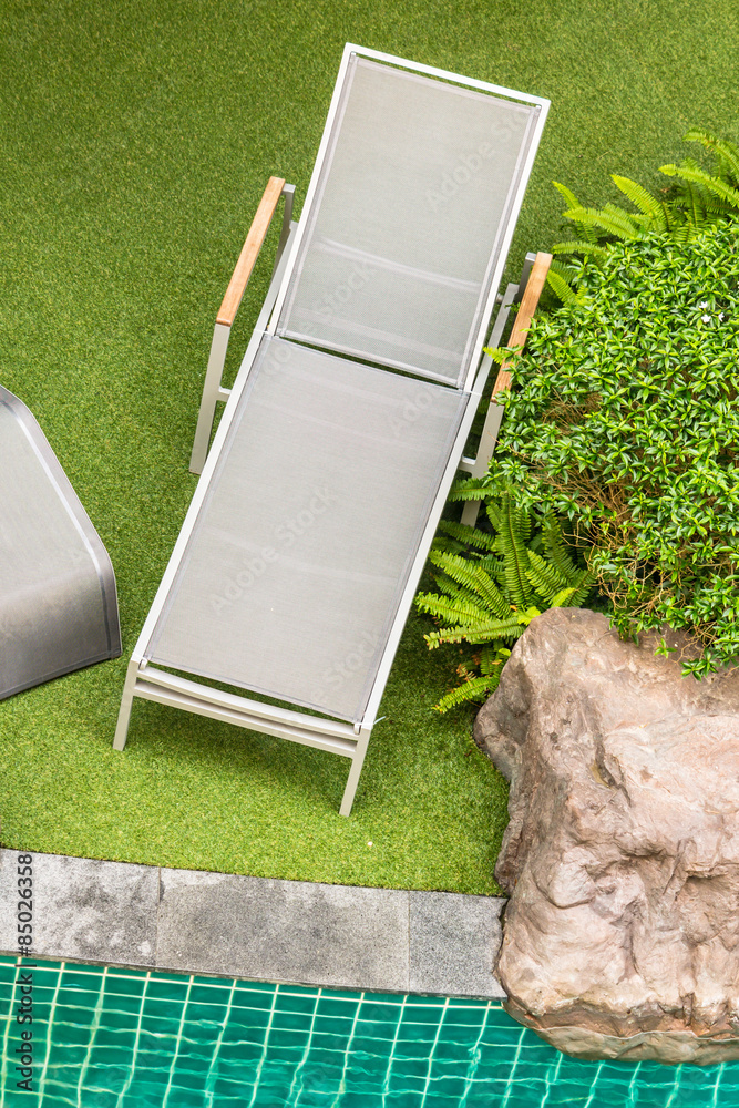 Swimming pool chair./ Top view relaxing poolside swimming pool chair. Stock Photo Adobe Stock