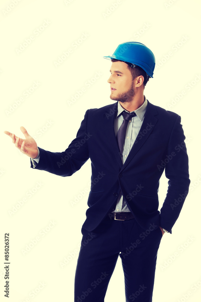 Businessman with hard hat holding copy space. Businessman with hard hat holding copy space.