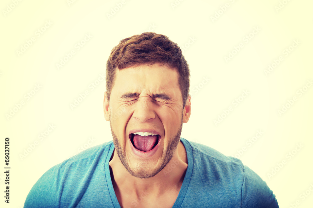 Handsome man screaming loud. Handsome man screaming loud.