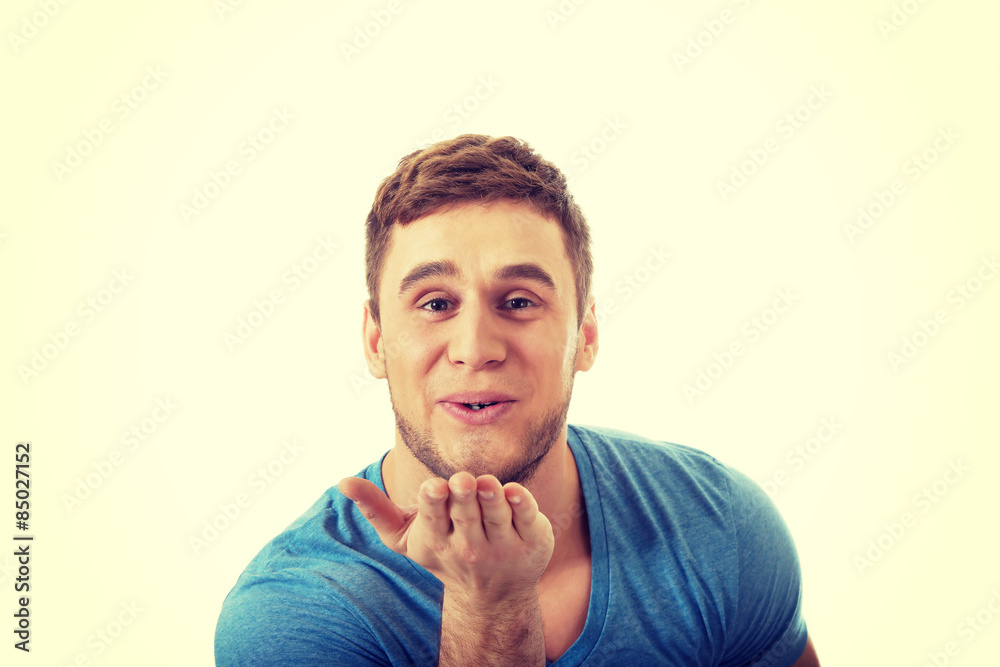 Young caucasian man sending a kiss. Young caucasian man sending a kiss.