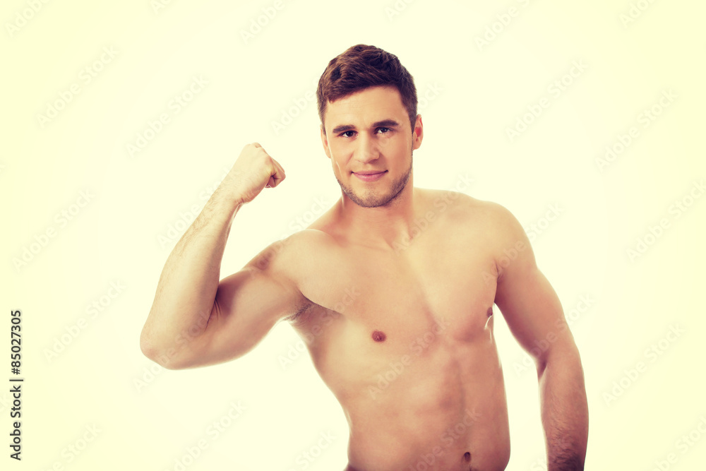 Fototapeta premium Young athletic man showing his muscles.