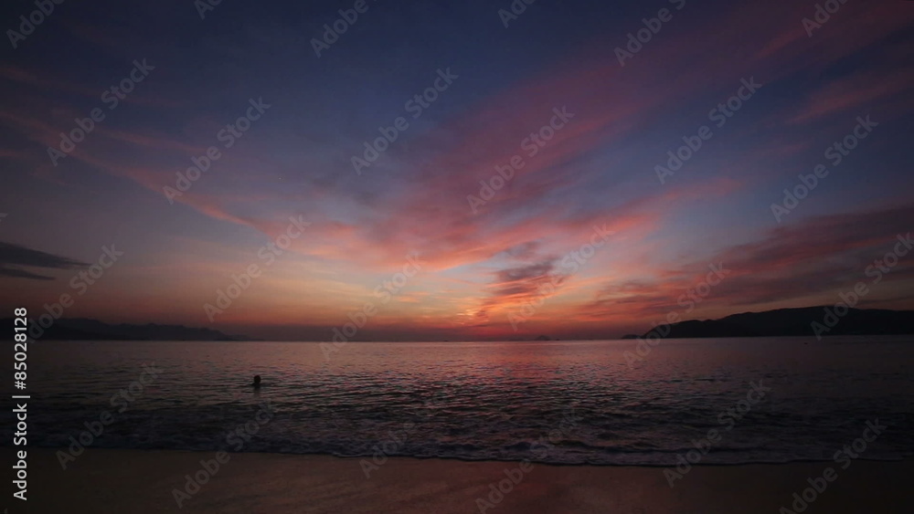 panorama of sun rays through dawn clouds above sea island and boat panorama of sun rays through dawn clouds above sea island and boat