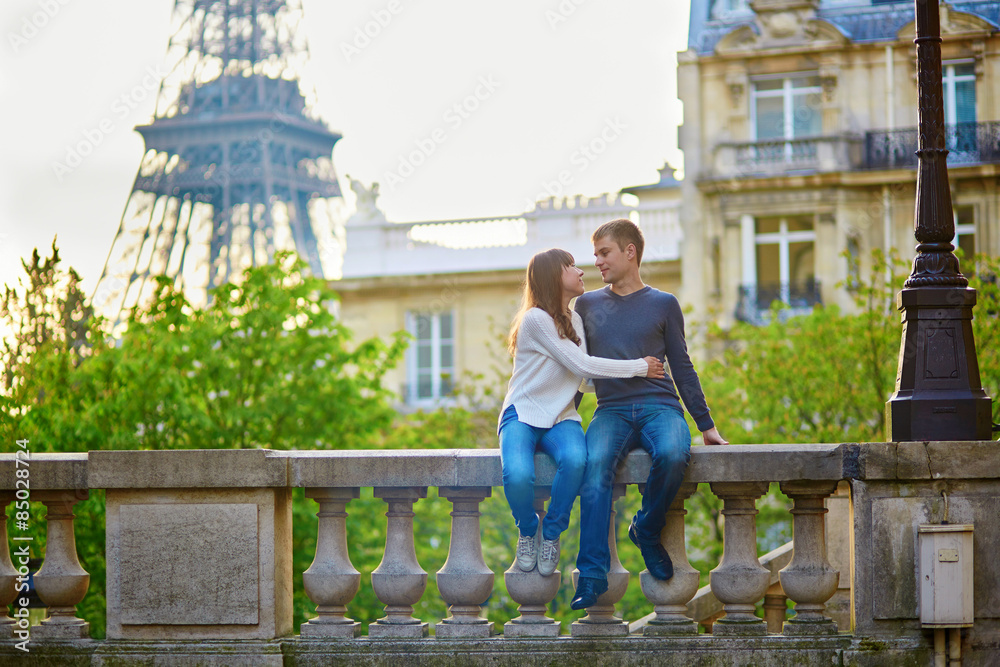 Romantic loving couple near the Eiffel tower Romantic loving couple near the Eiffel tower
