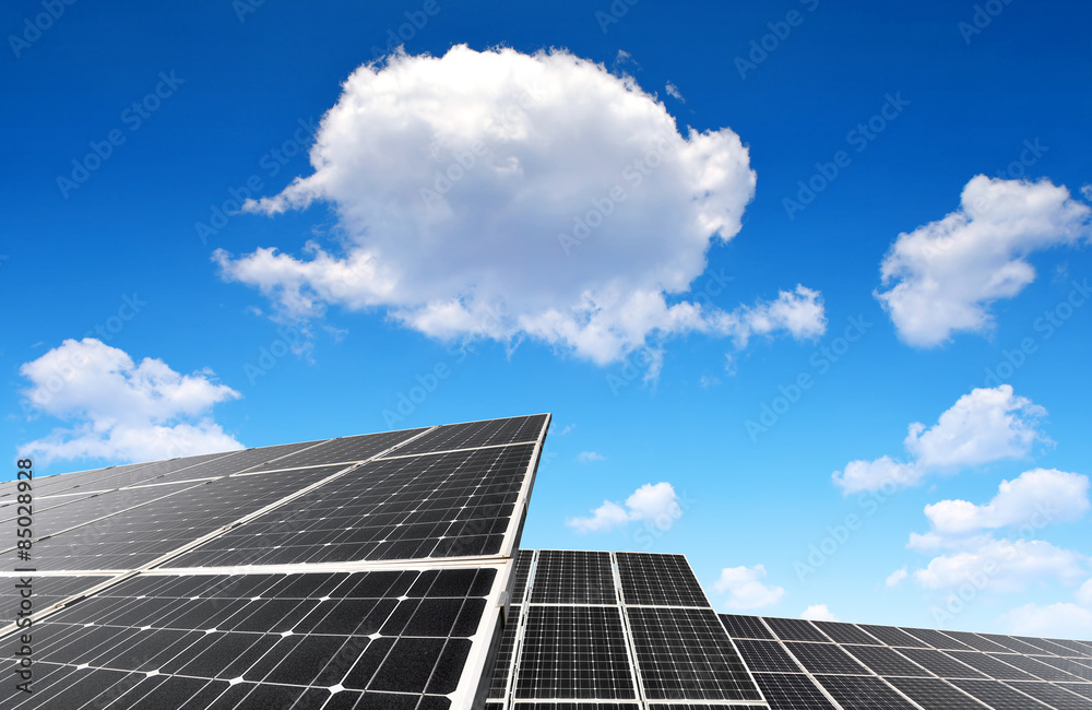 Solar panels against blue sky with clouds Solar panels against blue sky with clouds